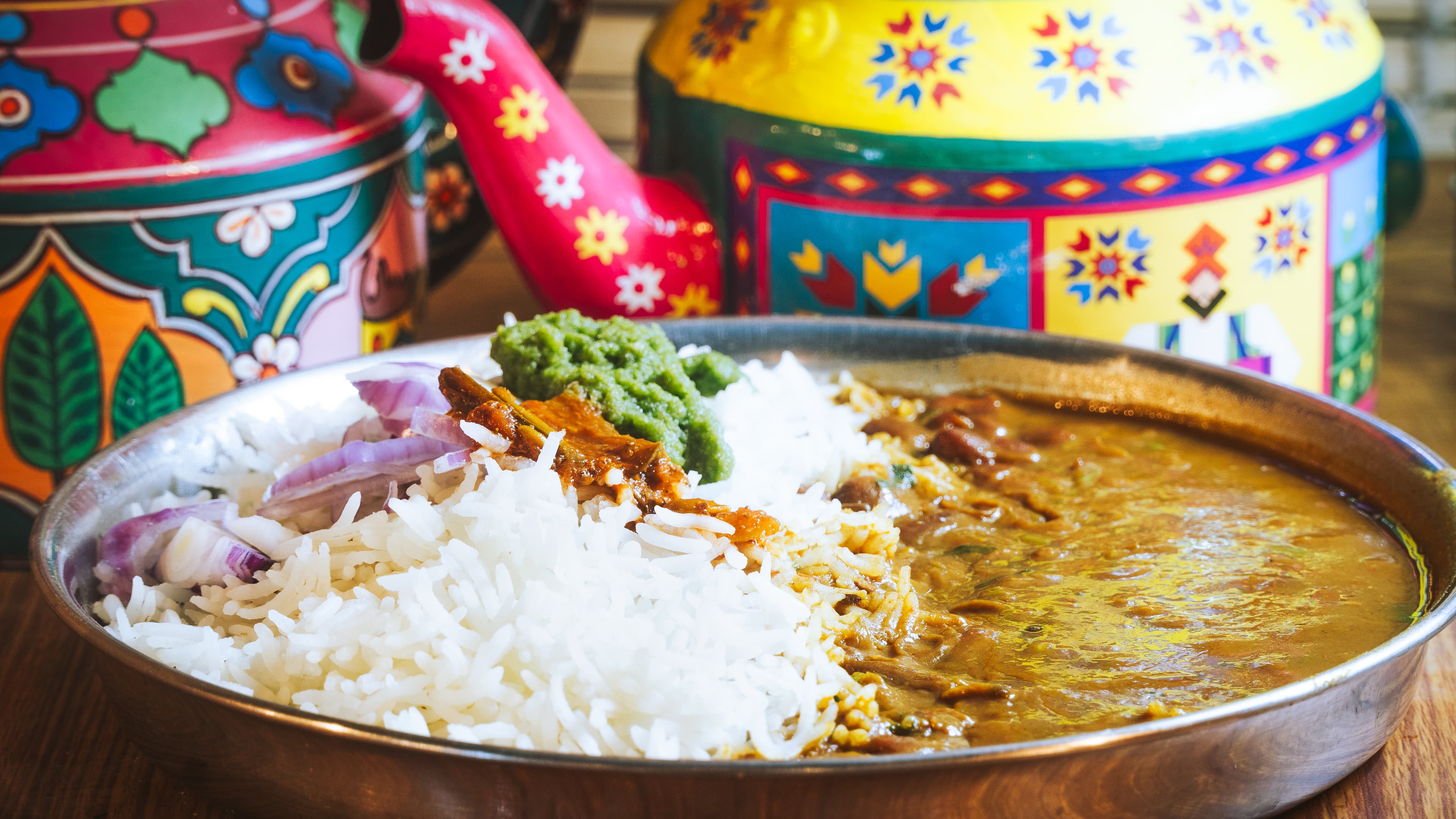 Rajma chawal thali with pickled onion and green chutney