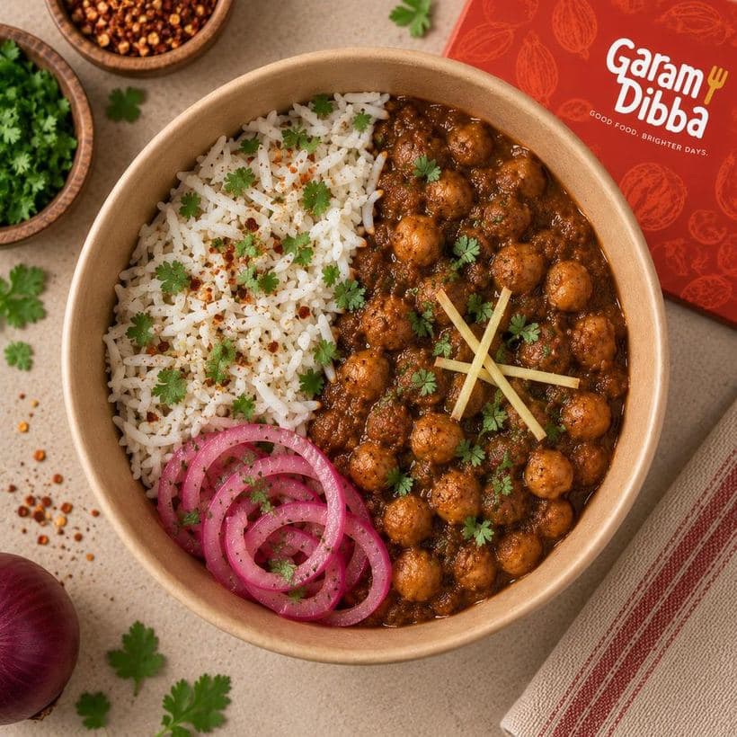 Pindi Chole bowl with spiced chickpeas, rice, pickled onion rings and ginger juliennes